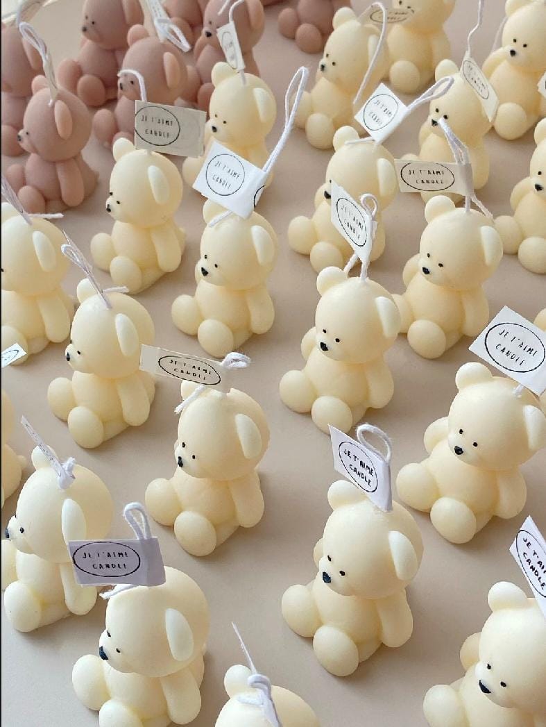Small teddy bears with tags on a neutral background