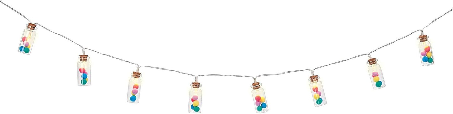 String lights with colorful beads and small bottles on a white background