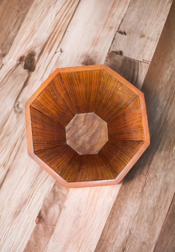 Wooden octagonal bowl on a wooden surface