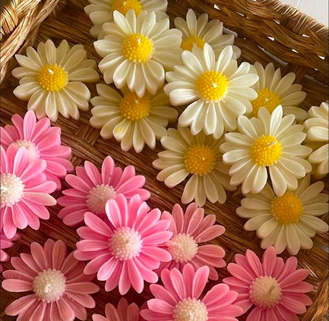 Decorative flowers in pink and white on a woven surface