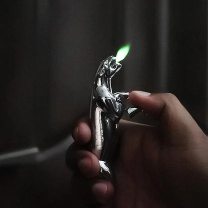 Hand holding a car emblem lighter with a lit flame against a dark background