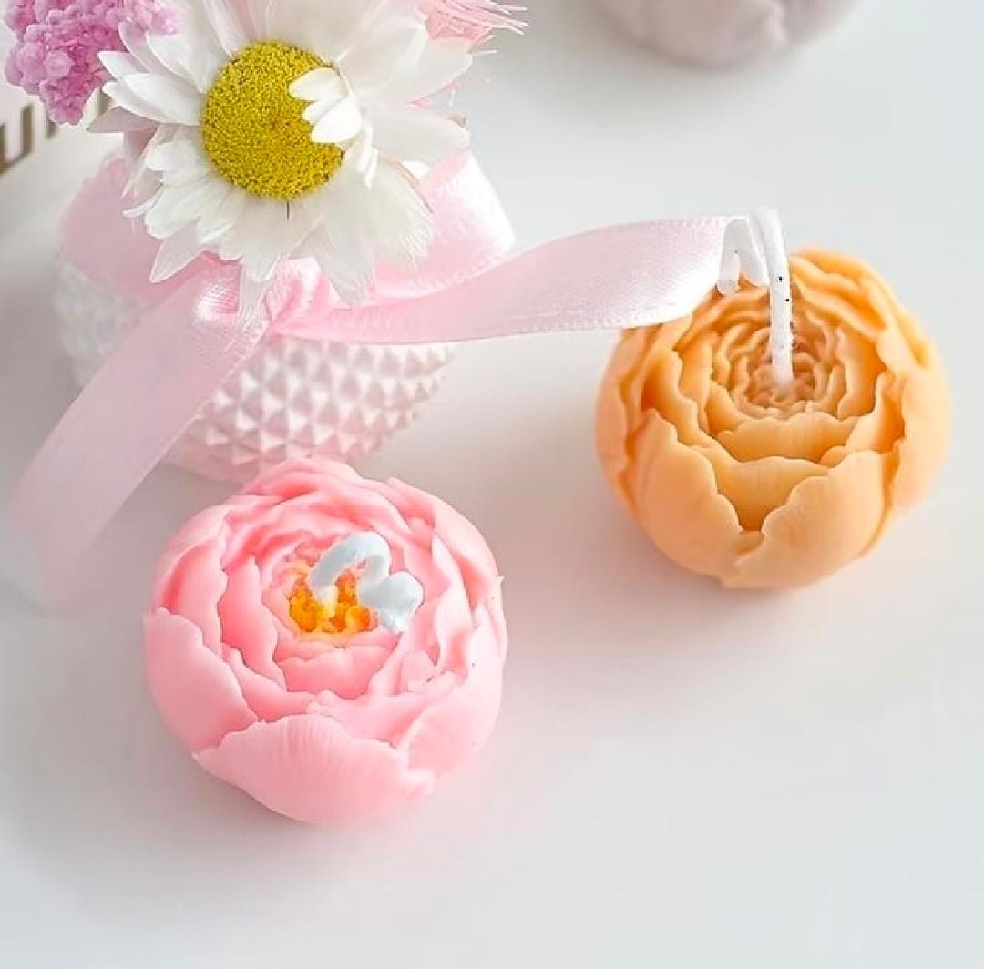 Decorative candles shaped like flowers on a light background