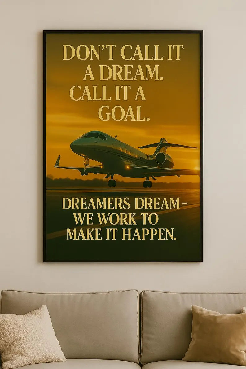 Framed motivational poster with airplane silhouette and text on a wall above a sofa.