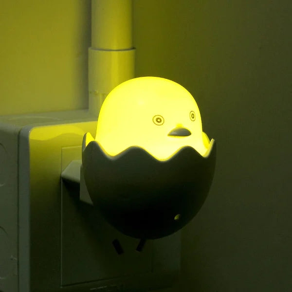Yellow duck night light attached to a wall socket.