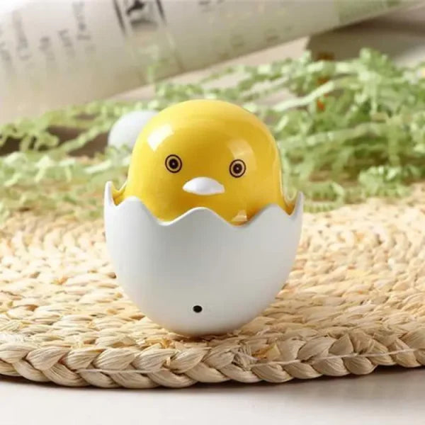 Yellow chick in an egg壳 on a woven mat