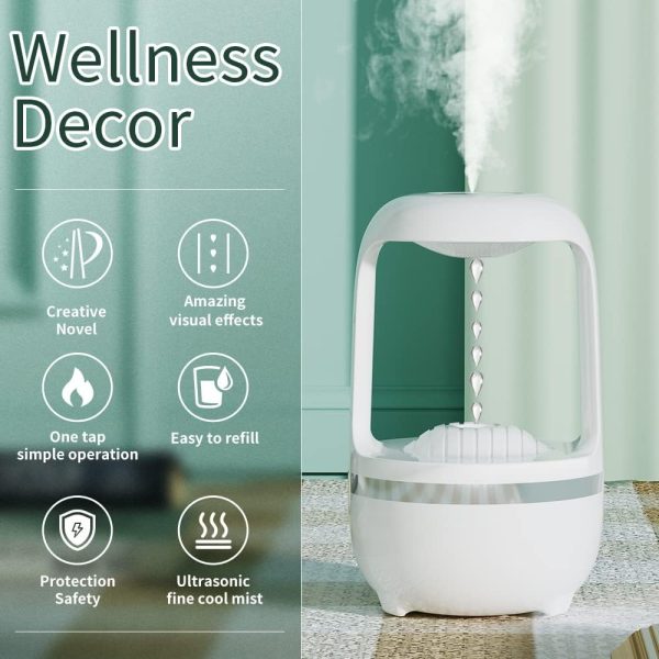 White ultrasonic humidifier on a table with text highlighting features against a green curtain background