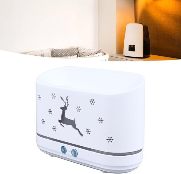 White humidifier with deer design on a nightstand next to a bed.
