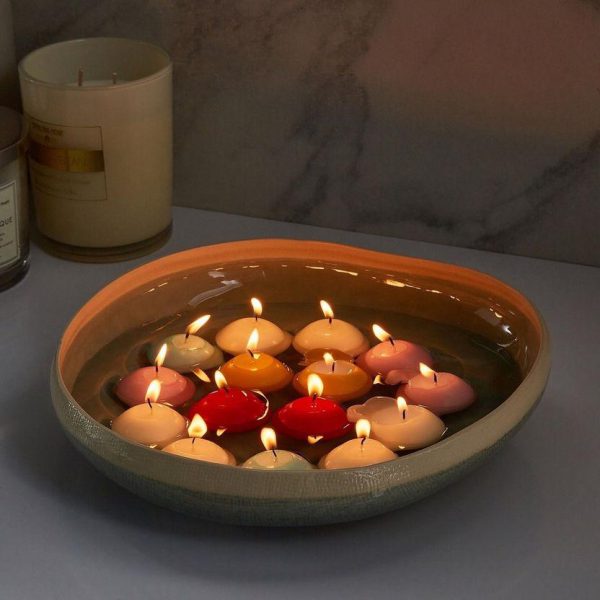 Decorative bowl with floating candles on a table