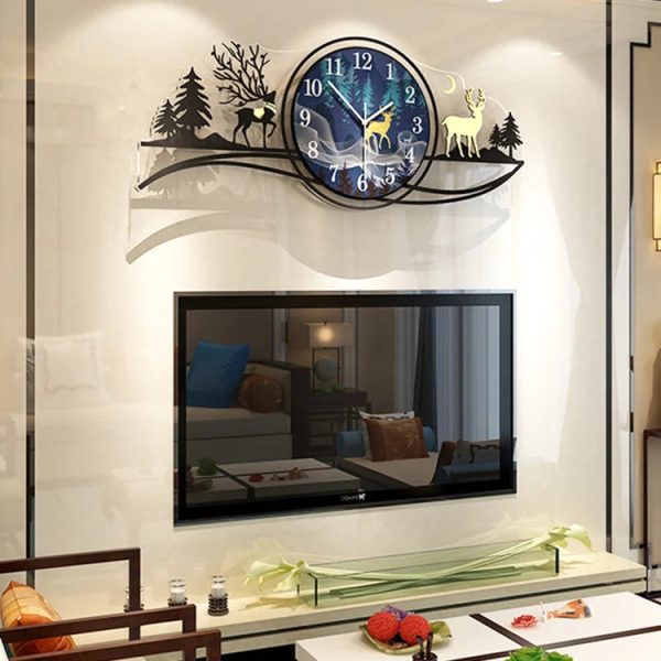 Decorative wall clock with deer design above a television in a living room.