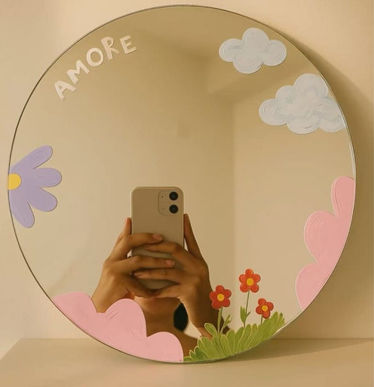 Round mirror with decorative elements and 'AMORE' text on a beige background