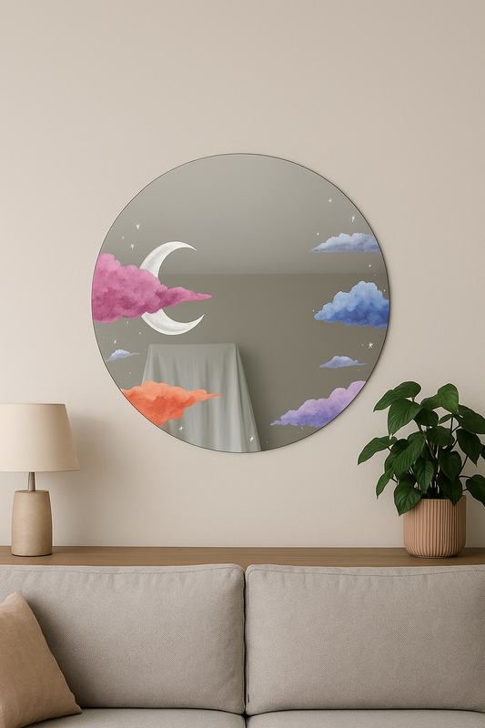 Round decorative mirror with cloud and moon design on a wall above a sofa.