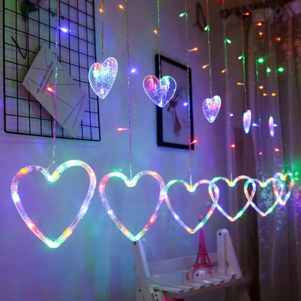 Heart-shaped LED string lights hanging in a room with a whiteboard and decor.
