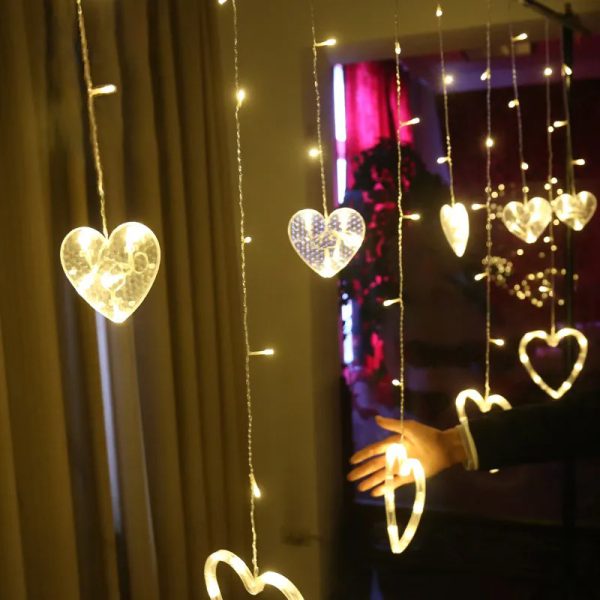 Heart-shaped LED lights hanging against a dark background