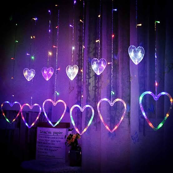 Heart-shaped LED string lights hanging against a dark background