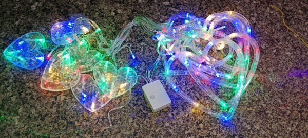 String lights with a power adapter on a carpeted floor