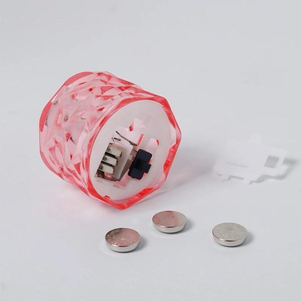Pink transparent container with electronic components on a white background