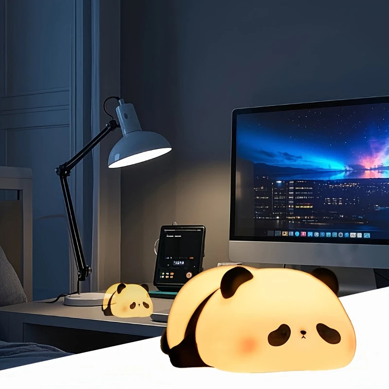 Panda-shaped night lights on a desk with a lamp and computer monitor in the background.