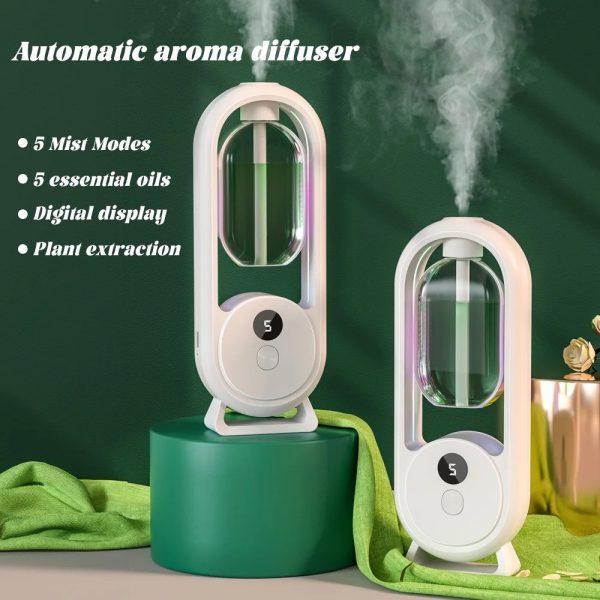 Automatic aroma diffuser with mist modes and essential oils on a green background