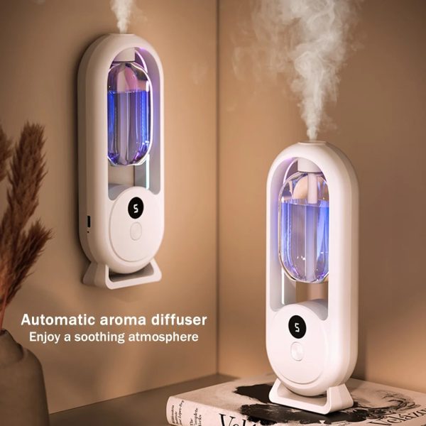 Automatic aroma diffuser emitting mist on a shelf with decorative items.